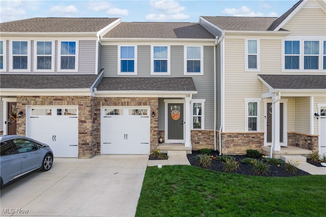 multi unit property featuring a front yard and a garage