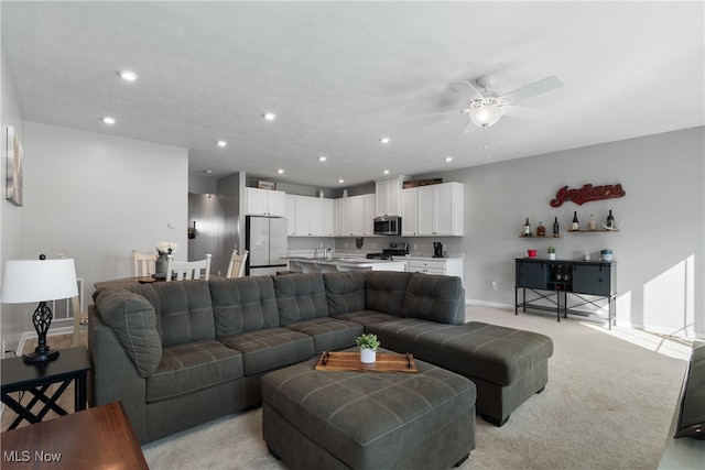 living room with light colored carpet and ceiling fan