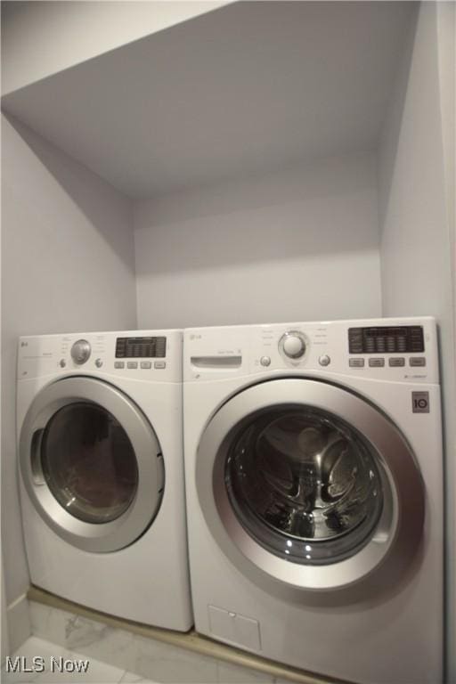 laundry area with independent washer and dryer