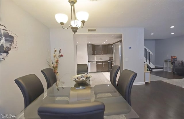 dining room featuring an inviting chandelier and light hardwood / wood-style floors