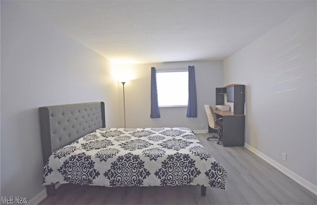 bedroom with wood-type flooring