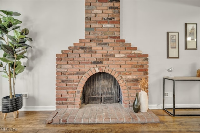 room details with a fireplace and hardwood / wood-style flooring