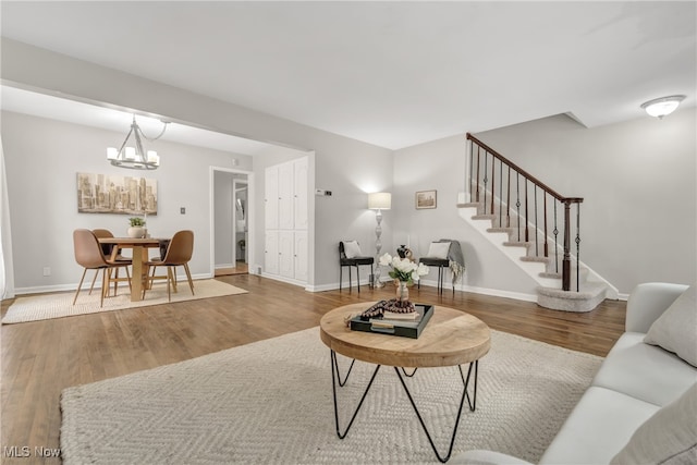 living room with hardwood / wood-style flooring and an inviting chandelier