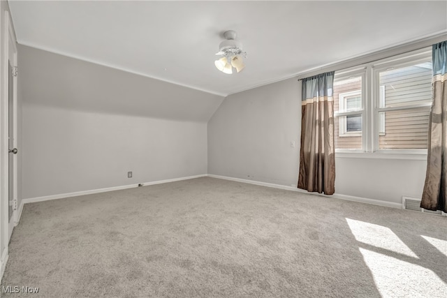 bonus room featuring light carpet, vaulted ceiling, and ceiling fan