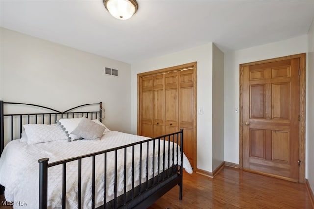 bedroom featuring wood-type flooring and a closet