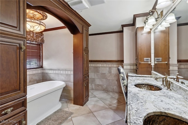 bathroom with tile patterned floors, tile walls, vanity, crown molding, and a tub to relax in