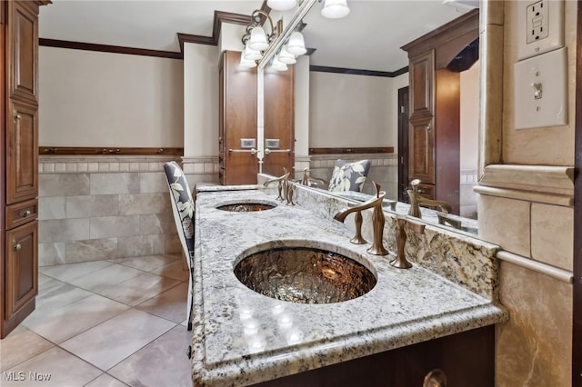 bathroom featuring tile walls, ornamental molding, vanity, tile patterned flooring, and decorative columns