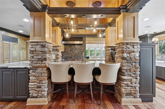 kitchen with light stone countertops, dark hardwood / wood-style floors, and ornamental molding