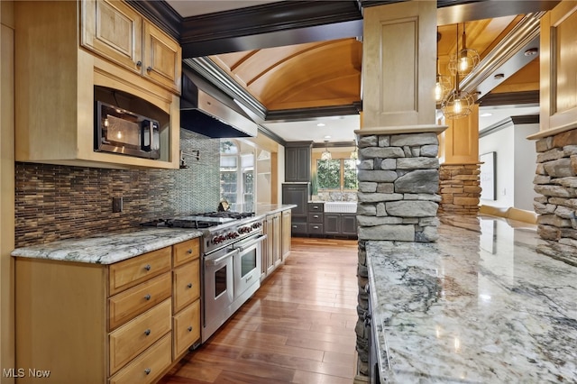 kitchen with hardwood / wood-style flooring, light stone counters, double oven range, backsplash, and crown molding