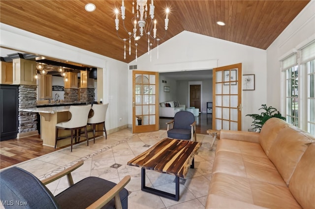 tiled living room with wooden ceiling, high vaulted ceiling, an inviting chandelier, and french doors