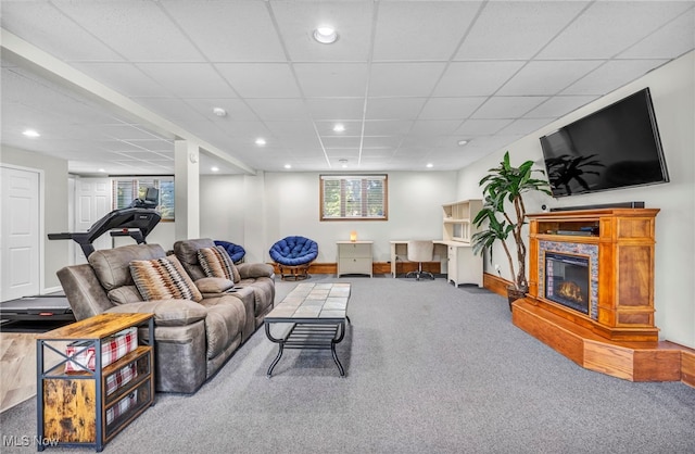 living room featuring a drop ceiling and carpet flooring