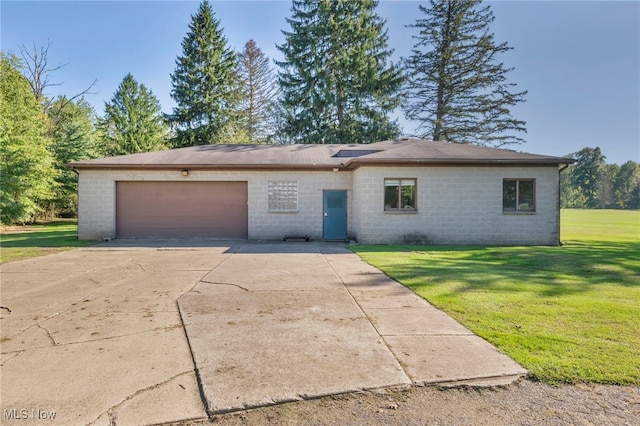 view of front of property with a front yard and a garage