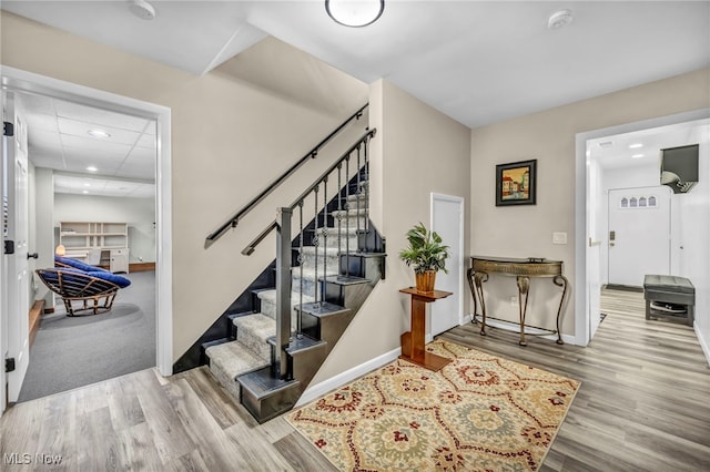 stairs with hardwood / wood-style floors