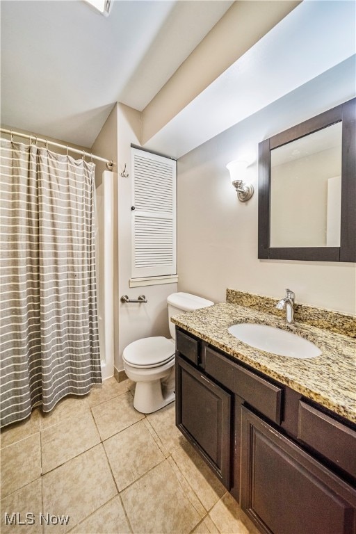 bathroom with vanity, a shower with curtain, toilet, and tile patterned flooring