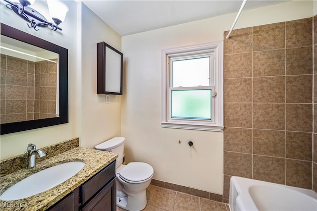 full bathroom featuring toilet, tiled shower / bath combo, vanity, and tile patterned floors