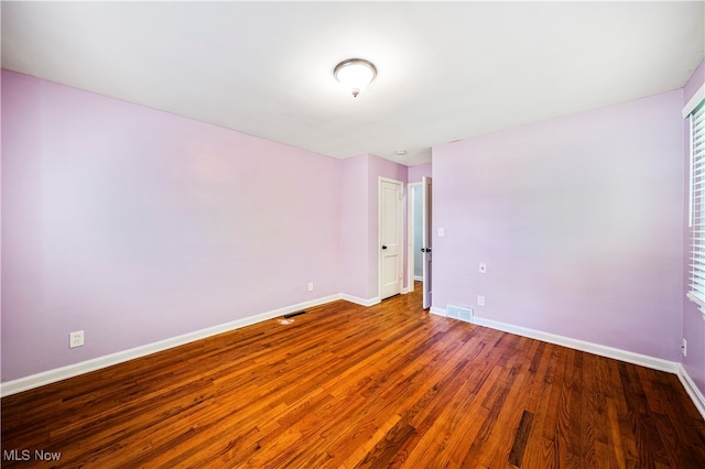 spare room with wood-type flooring