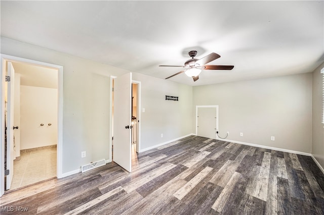 unfurnished room with ceiling fan and dark hardwood / wood-style flooring