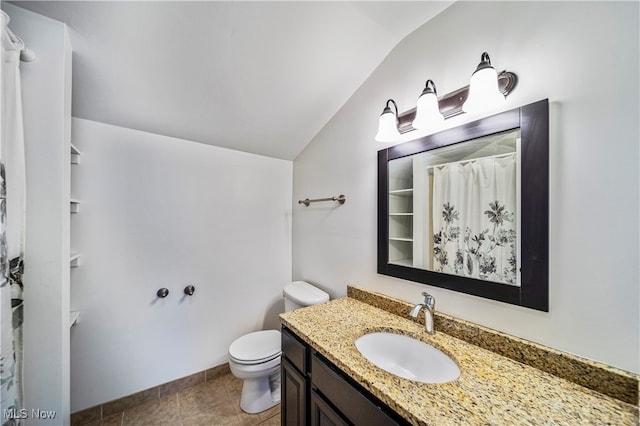 bathroom featuring vanity, vaulted ceiling, toilet, and tile patterned floors