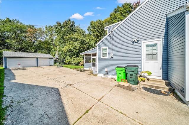 view of side of home with an outdoor structure and a garage