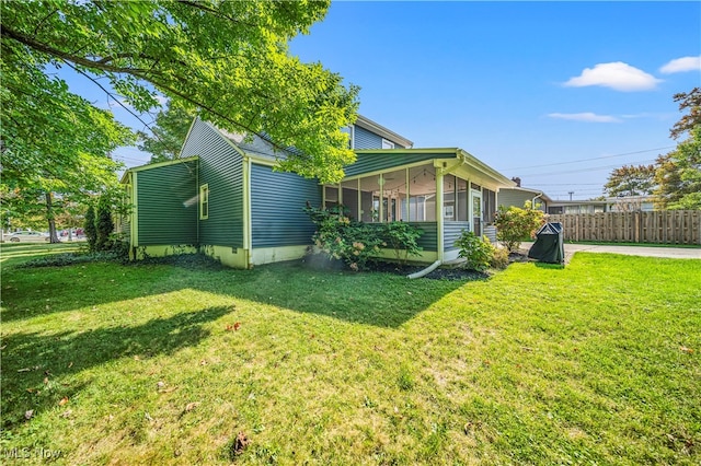 view of property exterior with covered porch and a yard