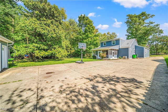 view of basketball court with a lawn