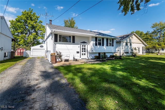 split foyer home with a storage shed and a front yard