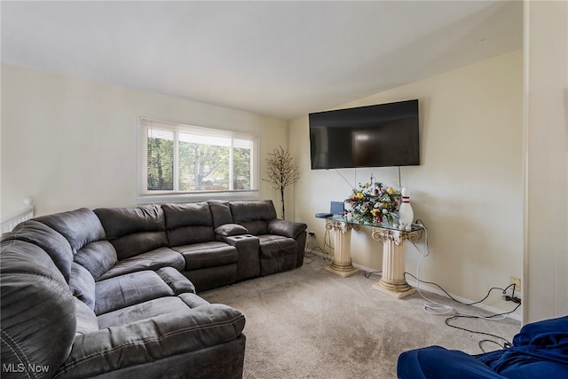 living room featuring carpet floors and lofted ceiling