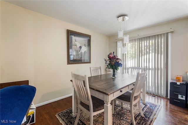 dining space featuring dark wood-type flooring