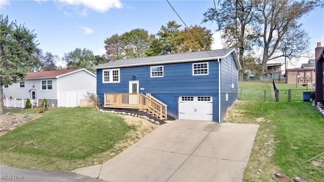 raised ranch featuring a front lawn and a garage