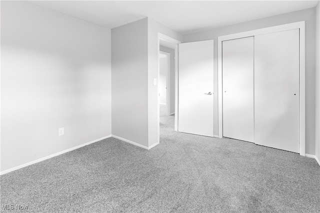 unfurnished bedroom featuring a closet and carpet floors