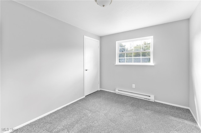 carpeted spare room featuring a baseboard radiator