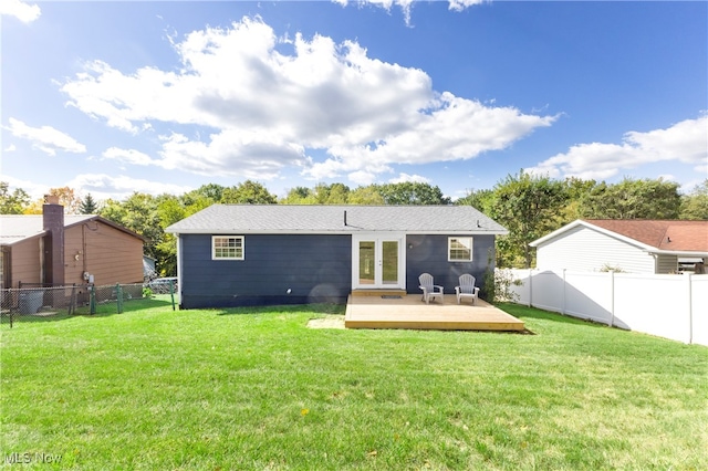 rear view of property featuring french doors, a deck, and a yard