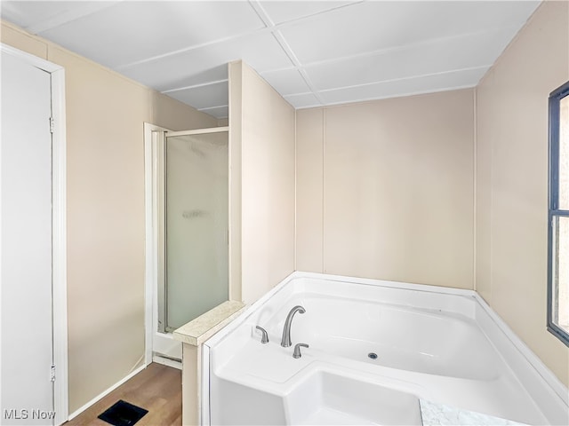 bathroom featuring shower with separate bathtub and hardwood / wood-style flooring