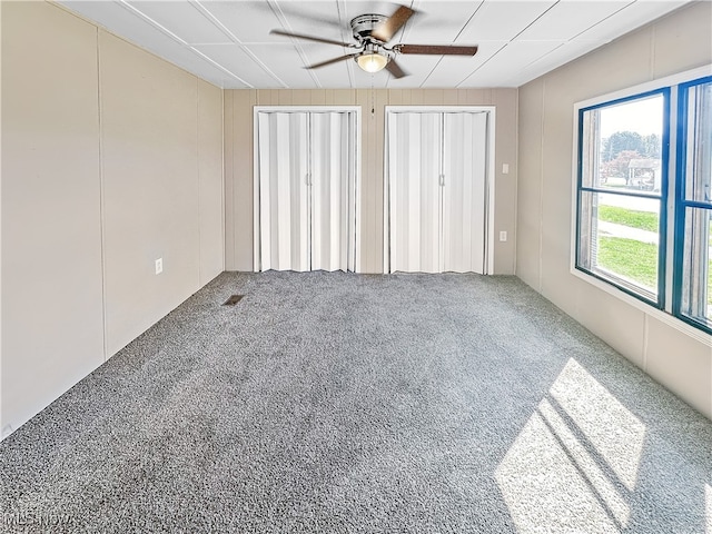 empty room with carpet flooring and ceiling fan