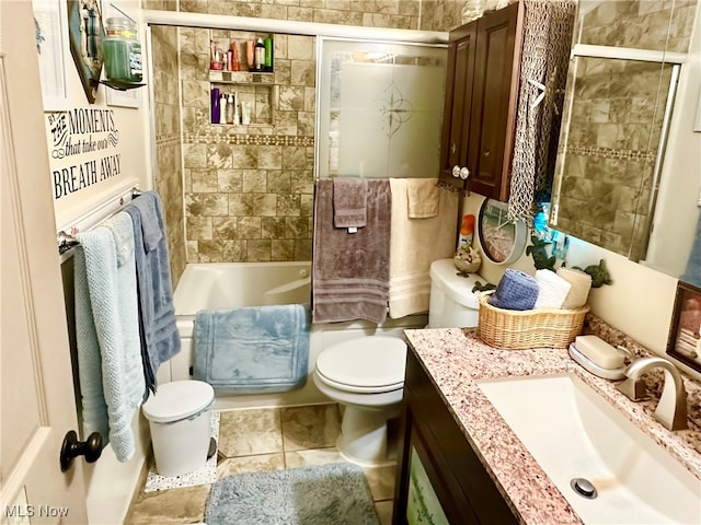 full bathroom with enclosed tub / shower combo, vanity, tile patterned flooring, and toilet