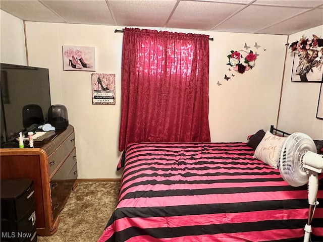 bedroom with a drop ceiling and carpet floors