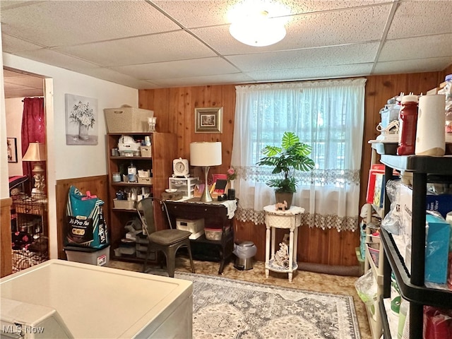 misc room featuring wooden walls and a paneled ceiling