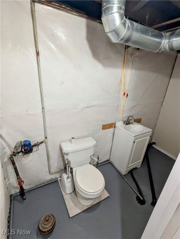 bathroom featuring toilet, concrete flooring, and vanity