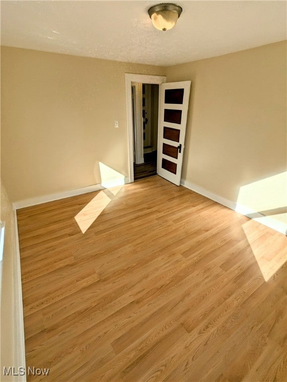 spare room featuring light hardwood / wood-style flooring