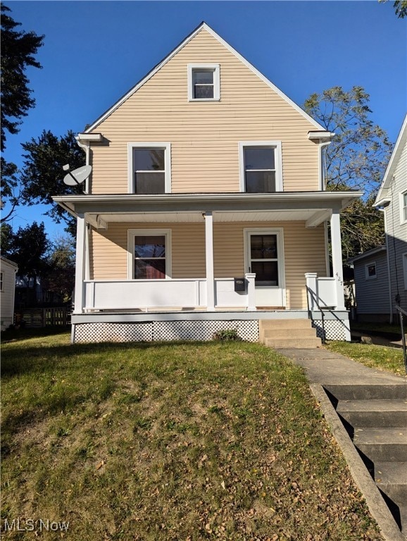 view of front of property with a front yard and a porch