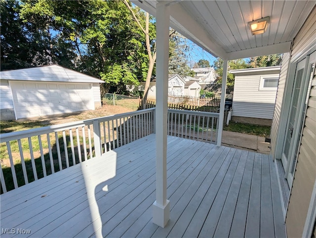 wooden deck with an outbuilding and a garage