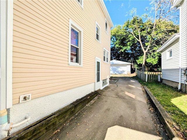 view of home's exterior featuring an outdoor structure and a garage