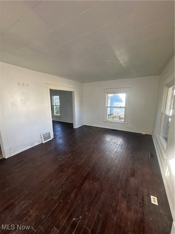 empty room with dark hardwood / wood-style floors