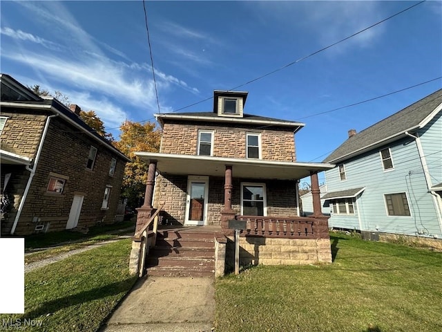 view of front of property with covered porch and a front yard