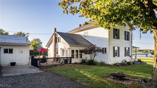 view of front of house with a front lawn and a wooden deck