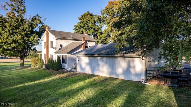 view of home's exterior with a lawn