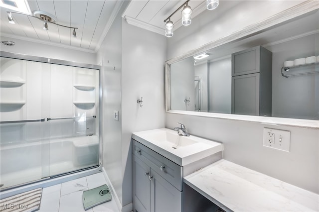 bathroom with vanity, crown molding, a shower with door, and rail lighting