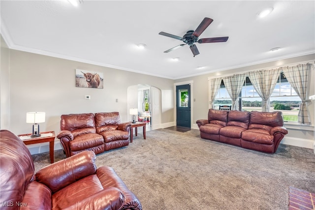 living room with carpet floors, crown molding, and a healthy amount of sunlight