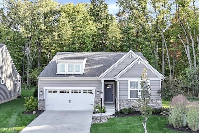 craftsman-style house with a garage and a front lawn