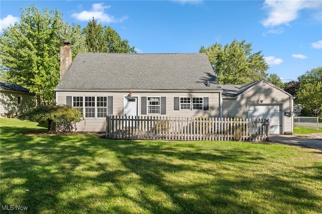 view of front of property featuring a front yard and a garage